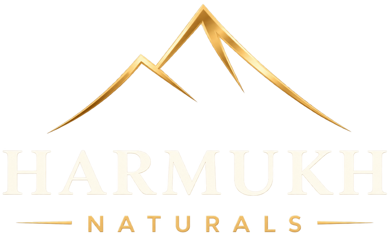 A gold and cream logo for 'Harmukh Naturals' featuring a stylized gold mountain above the brand name.